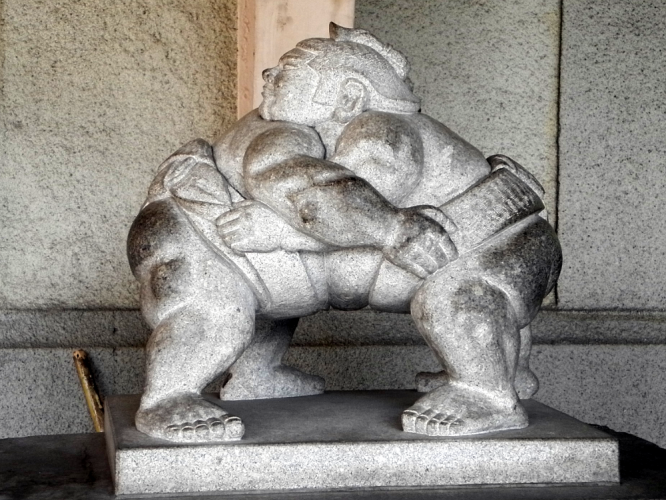 Sumo wrestlers stone sculpture, visiting a sumo tournament