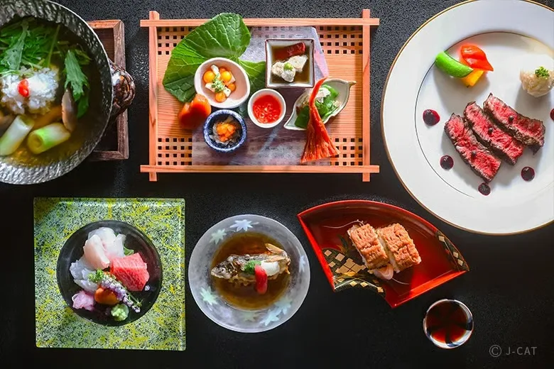 experiences_kyoto_private-geisha-entertainment-dinner-gion-kyoto_kaiseki-meal An overhead flat-lay view of an exquisite multi-course Kyoto kaiseki banquet served during a private geisha dinner in Gion, featuring fresh sashimi, grilled wagyu beef, seasonal appetizers, and simmered dishes in fine lacquer and ceramic ware.